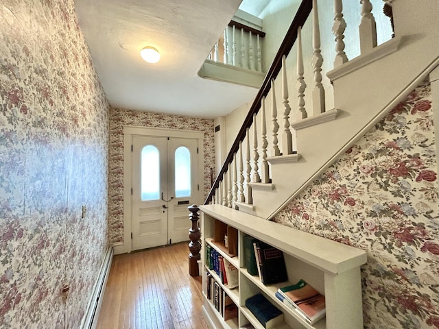 132 E Main St, Dover-Foxcroft, ME 04426 - entryway with wallpapered walls, light wood-style floors, stairs, and baseboard heating