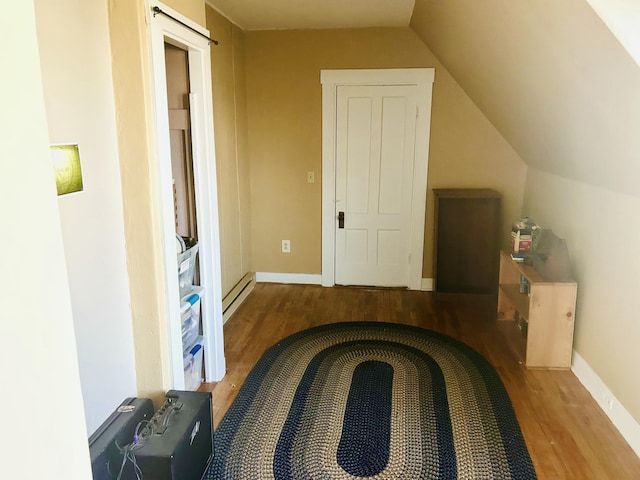 132 E Main St, Dover-Foxcroft, ME 04426 - bedroom featuring wood finished floors, a baseboard heating unit, lofted ceiling, and baseboards
