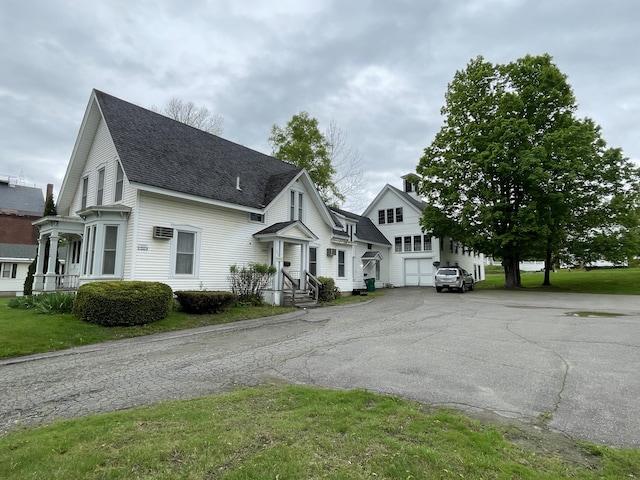 132 E Main St, Dover-Foxcroft, ME 04426 - traditional-style home with a shingled roof, driveway, and a garage