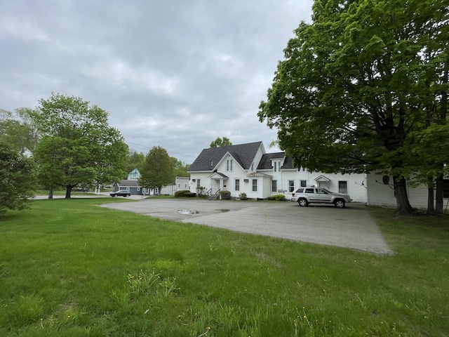 132 E Main St, Dover-Foxcroft, ME 04426 - rear view of house featuring a lawn