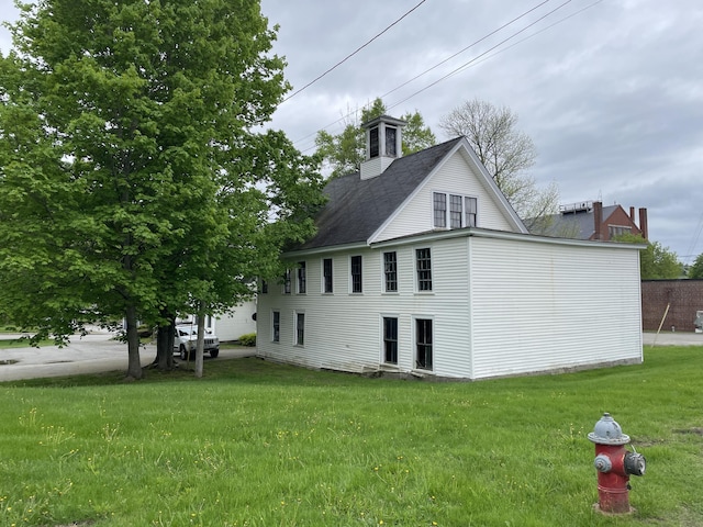 132 E Main St, Dover-Foxcroft, ME 04426 - view of side of property with a yard, a chimney, and a shingled roof
