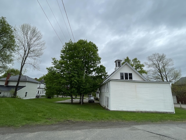 132 E Main St, Dover-Foxcroft, ME 04426 - view of property exterior with a chimney and a lawn