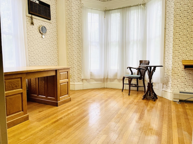 132 E Main St, Dover-Foxcroft, ME 04426 - sitting room with wallpapered walls, light wood-style flooring, and a baseboard radiator