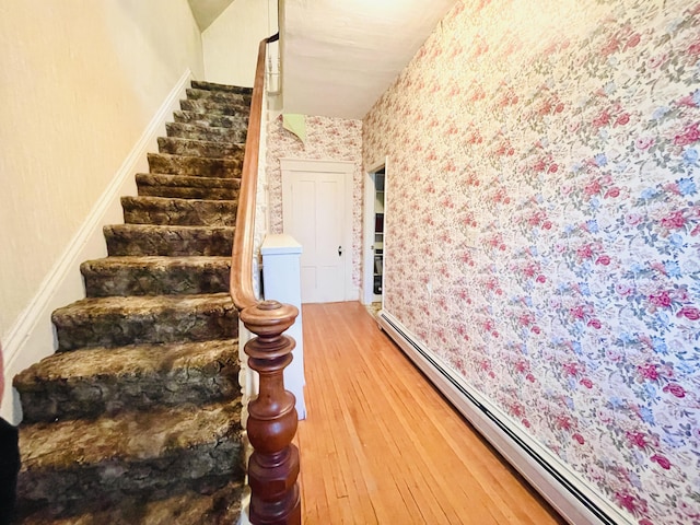 132 E Main St, Dover-Foxcroft, ME 04426 - stairs featuring a baseboard radiator, wallpapered walls, and wood-type flooring