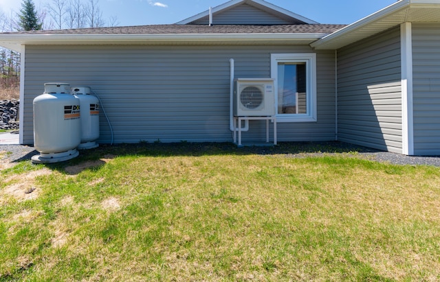 308 19th Ave Unit 101, Madawaska, ME 04756 - back of property featuring a yard, roof with shingles, and ac unit
