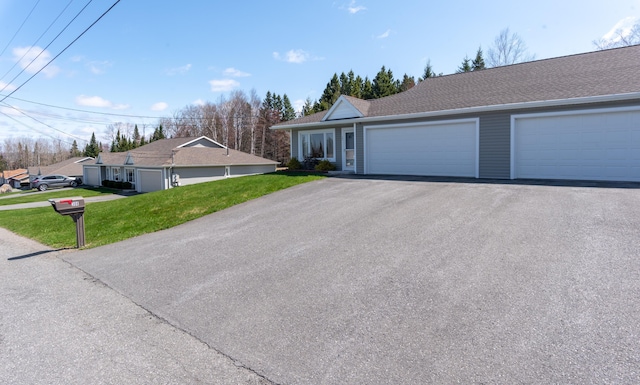 308 19th Ave Unit 101, Madawaska, ME 04756 - single story home featuring a front lawn, asphalt driveway, and a garage