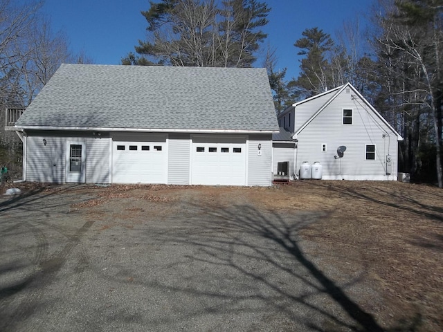 8 Varney Loop, Crawford, ME 04694 - view of side of home featuring roof with shingles and a garage