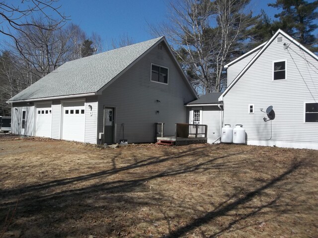 8 Varney Loop, Crawford, ME 04694 - view of property exterior with roof with shingles, a deck, and a detached garage