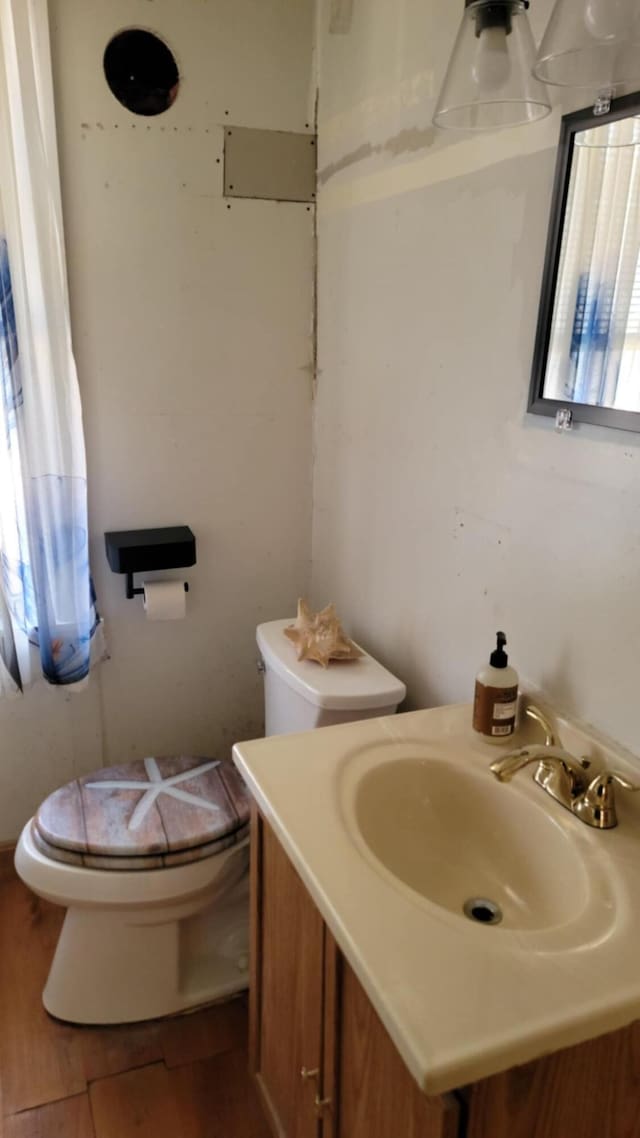 5 Johnson St, Eastport, ME 04631 - bathroom with wood finished floors, toilet, and vanity