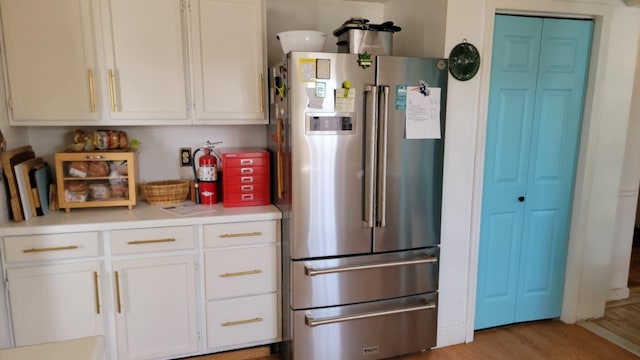 5 Johnson St, Eastport, ME 04631 - kitchen with white cabinetry, light countertops, light wood-style flooring, and high end refrigerator