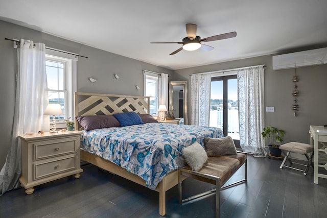 51 Bridge St, Belfast, ME 04915 - bedroom with a wall mounted air conditioner, dark wood-style flooring, access to outside, and a ceiling fan