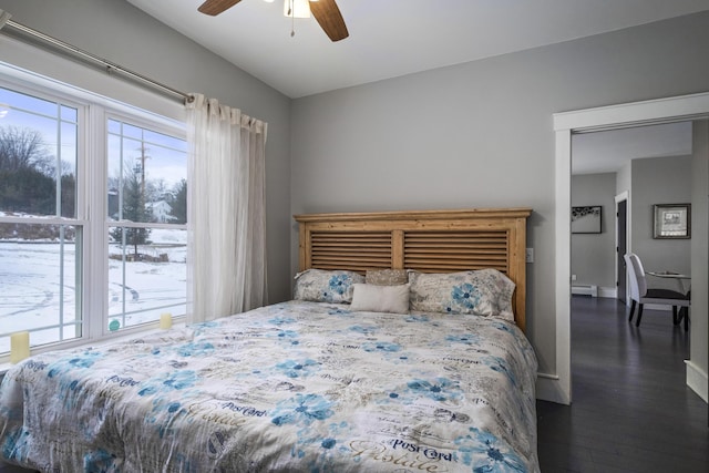 51 Bridge St, Belfast, ME 04915 - bedroom with a baseboard heating unit, dark wood-style flooring, baseboards, and a ceiling fan