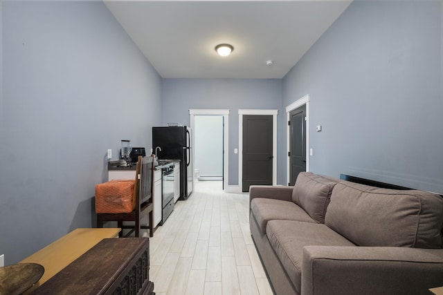 51 Bridge St, Belfast, ME 04915 - living room featuring baseboards and light wood finished floors