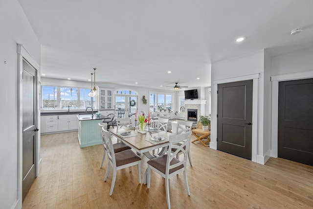 51 Bridge St, Belfast, ME 04915 - dining area with light wood-style flooring, ceiling fan, recessed lighting, and a fireplace