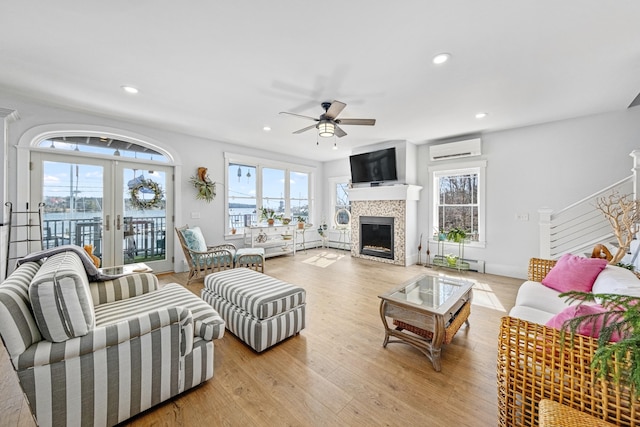 51 Bridge St, Belfast, ME 04915 - living room featuring a wall mounted AC, a ceiling fan, plenty of natural light, and a tile fireplace