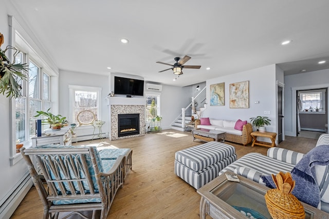 51 Bridge St, Belfast, ME 04915 - living room with a tile fireplace, baseboard heating, a baseboard radiator, and ceiling fan