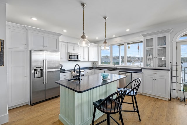 51 Bridge St, Belfast, ME 04915 - kitchen with a healthy amount of sunlight, light wood finished floors, dark countertops, and stainless steel appliances