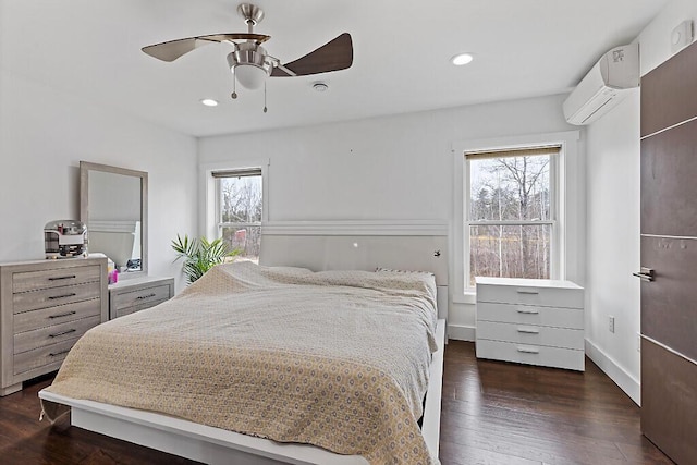 bedroom featuring dark wood finished floors, a ceiling fan, a wall mounted AC, and recessed lighting