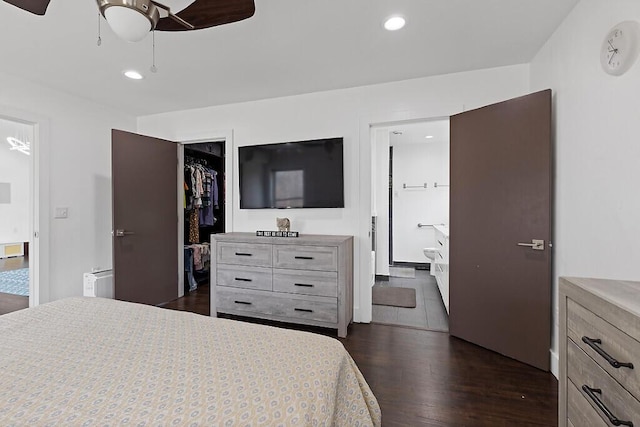 bedroom featuring recessed lighting, dark wood finished floors, a spacious closet, a closet, and ensuite bath