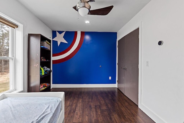bedroom with baseboards and wood finished floors