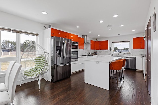 kitchen with modern cabinets, dark wood-style flooring, stainless steel appliances, and extractor fan