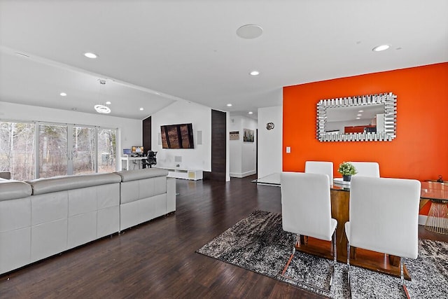 dining area featuring vaulted ceiling, wood finished floors, and recessed lighting