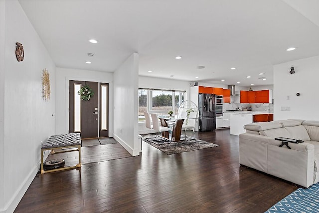 living area with recessed lighting and dark wood-style floors