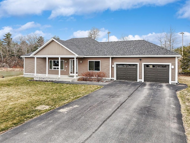 ranch-style house featuring roof with shingles, a front lawn, driveway, covered porch, and a garage