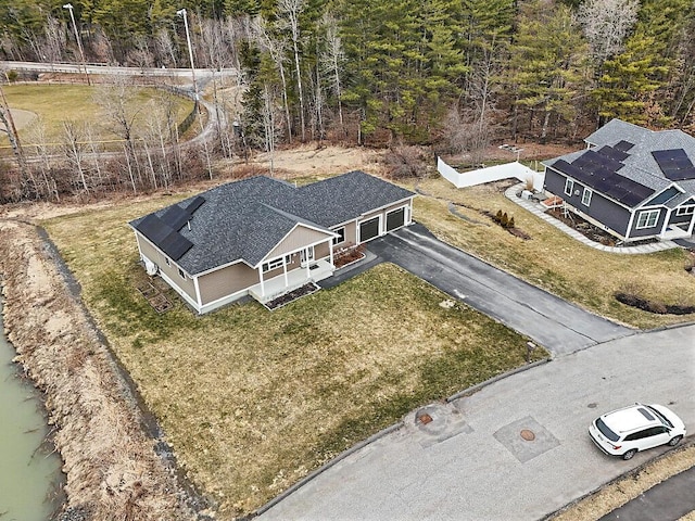 drone / aerial view featuring a forest view