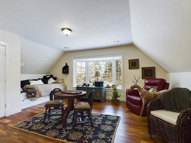 dining room with baseboards, vaulted ceiling, and wood-type flooring