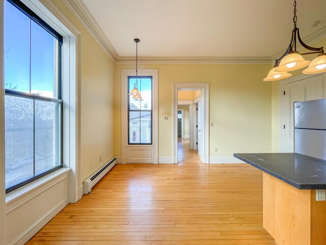 727 Congress St Unit 5, Portland, ME 04102 - unfurnished dining area featuring ornamental molding, a baseboard heating unit, light wood-type flooring, and plenty of natural light