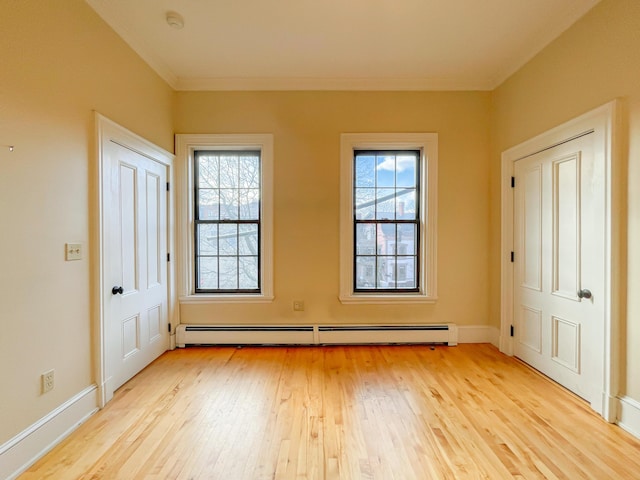 727 Congress St Unit 5, Portland, ME 04102 - interior space with baseboards, light wood-style floors, a baseboard heating unit, and ornamental molding
