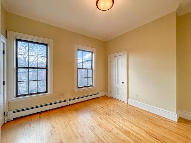 727 Congress St Unit 5, Portland, ME 04102 - unfurnished room featuring baseboards, ornamental molding, a baseboard heating unit, and light wood finished floors