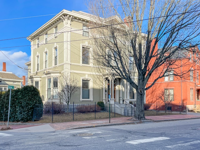 727 Congress St Unit 5, Portland, ME 04102 - view of front of house with stucco siding and a fenced front yard