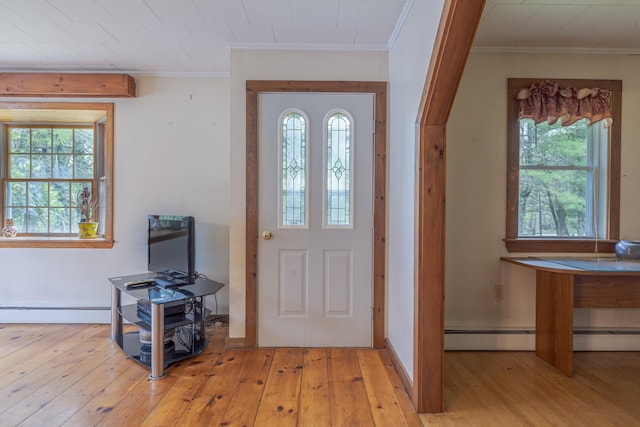 927 Pleasant St, Blue Hill, ME 04614 - foyer entrance with ornamental molding, hardwood / wood-style floors, and a baseboard heating unit