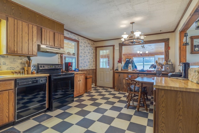 927 Pleasant St, Blue Hill, ME 04614 - kitchen with black appliances, light flooring, under cabinet range hood, a wainscoted wall, and a chandelier