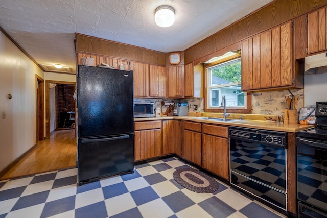 927 Pleasant St, Blue Hill, ME 04614 - kitchen featuring black appliances, a sink, light floors, light countertops, and brown cabinetry