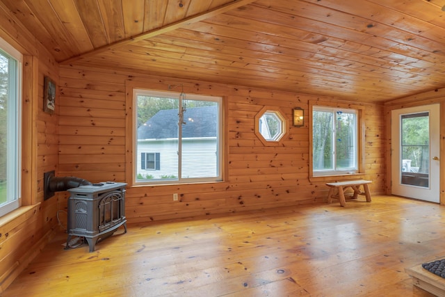 927 Pleasant St, Blue Hill, ME 04614 - interior space with wood ceiling, a wood stove, vaulted ceiling, wood walls, and light wood-style flooring