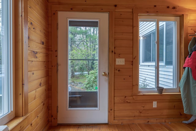 927 Pleasant St, Blue Hill, ME 04614 - entryway featuring healthy amount of natural light, light wood-type flooring, and wood walls