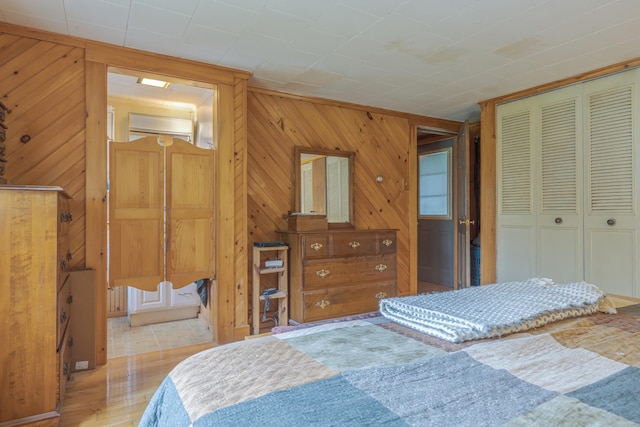 927 Pleasant St, Blue Hill, ME 04614 - bedroom featuring a closet, wooden walls, and wood finished floors
