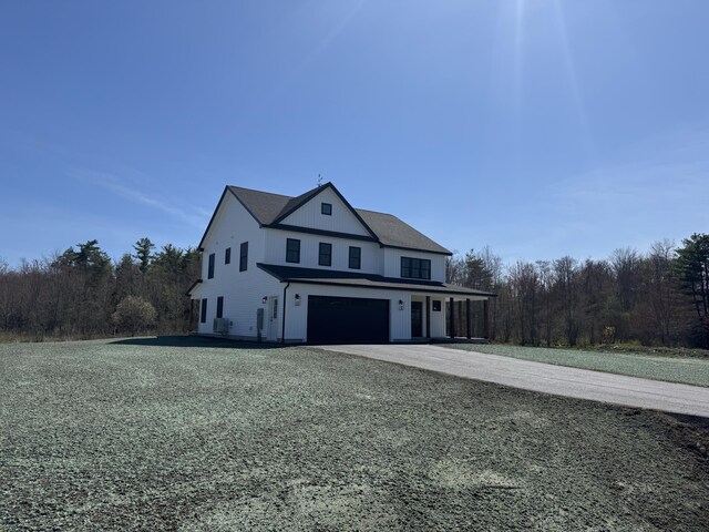 view of home's exterior with an attached garage and aphalt driveway
