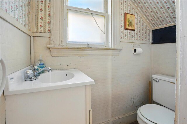 14 Central St, Winthrop, ME 04364 - half bathroom featuring toilet, vanity, and wallpapered walls