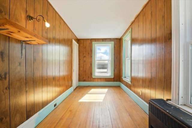 14 Central St, Winthrop, ME 04364 - unfurnished room with light wood-style floors, wood walls, heating unit, and baseboards