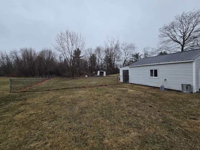 view of yard with an outdoor structure and fence