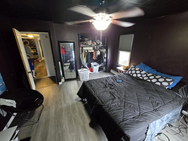 bedroom featuring a closet, wood finished floors, and a ceiling fan