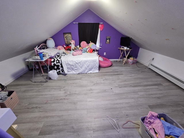 bedroom featuring baseboards, vaulted ceiling, and wood finished floors