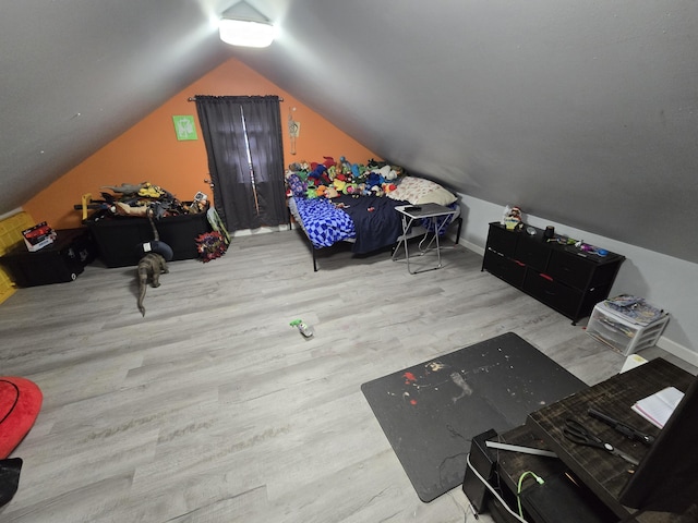 bonus room with baseboards, vaulted ceiling, and wood finished floors