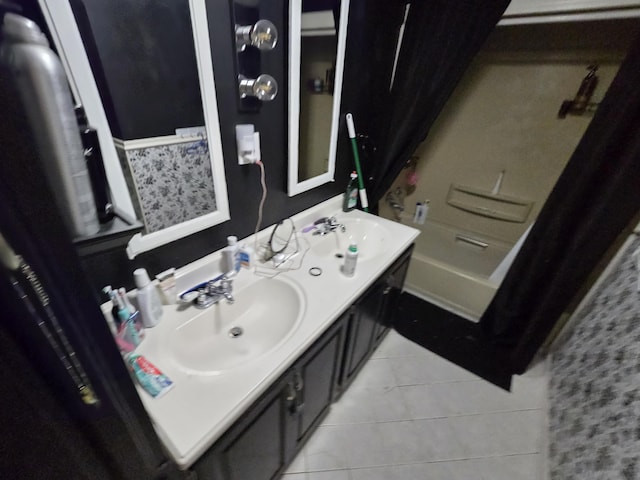full bath with double vanity, a sink, tile patterned flooring, and walk in shower