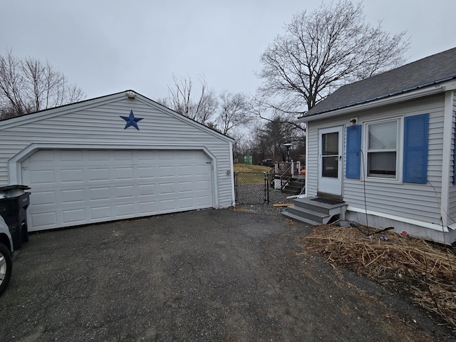 garage featuring a gate and fence