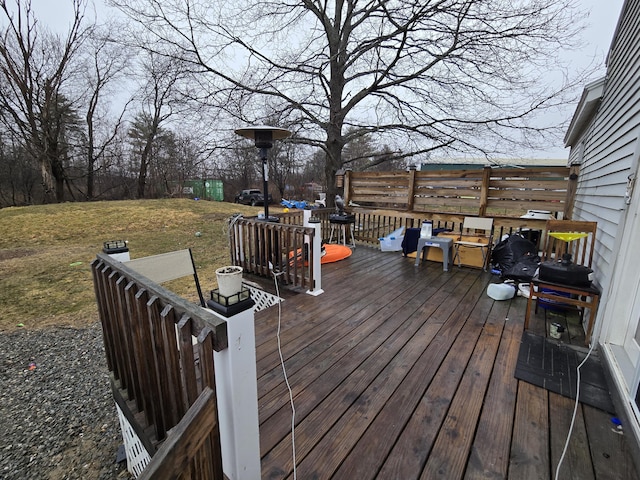 wooden deck featuring a yard